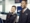 A female and male JetBlue flight attendant smiling at the airport